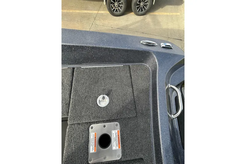 Slide: The Image of 2026 Lund 219 Pro-V GL boat deck with storage compartments and handle. - 45