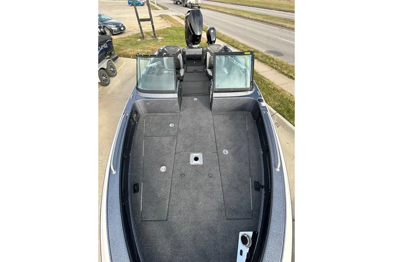 Slide: The Image of 2026 Lund 219 Pro-V GL boat interior with spacious deck and windshield view. - 46