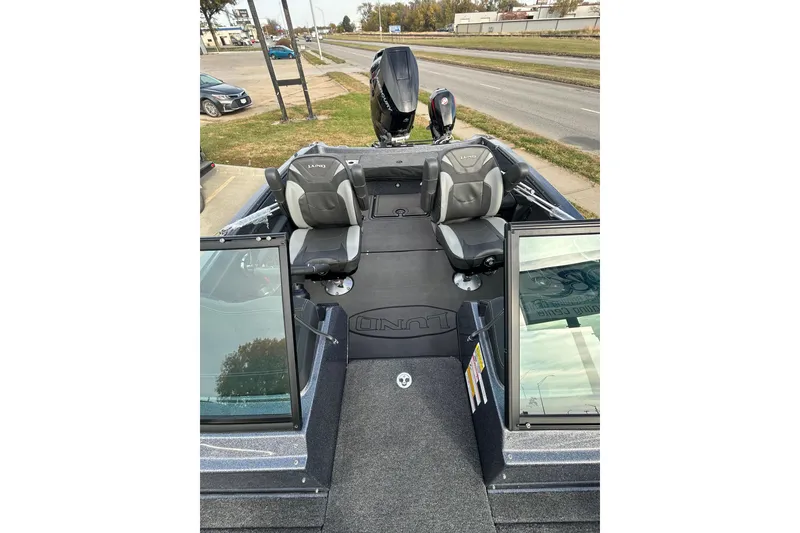 Slide: The Image of 2026 Lund 219 Pro-V GL boat interior with two seats and open windshield. - 48