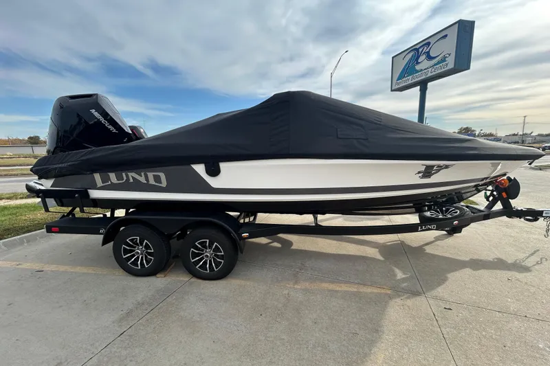 Slide: The Image of 2026 Lund 219 Pro-V GL boat on trailer, covered, at Premier Boating Center. - 5
