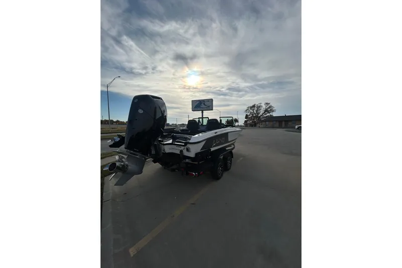 Slide: The Image of 2026 Lund 219 Pro-V GL boat on trailer, covered, with Mercury outboard motor. - 6