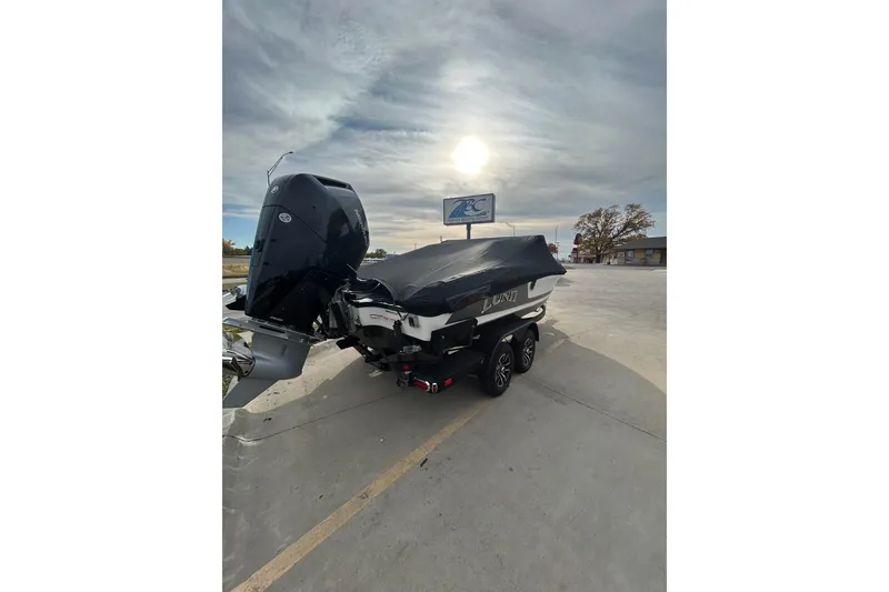 Slide: The Image of 2026 Lund 219 Pro-V GL boat parked on snowy lot under a clear sky. - 7