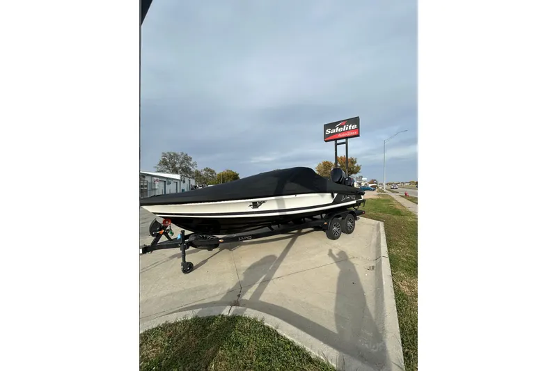 Slide: The Image of 2026 Lund 219 Pro-V GL boat on trailer, covered, with Mercury outboard motor. - 8