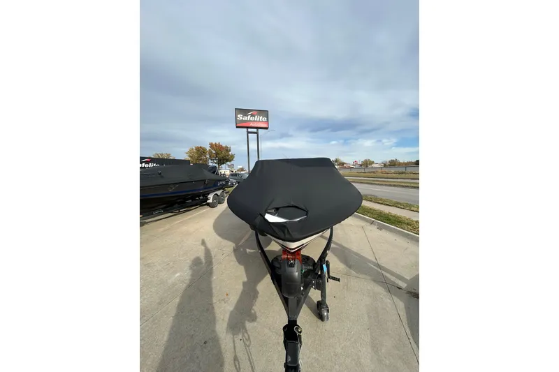 Slide: The Image of 2026 Lund 219 Pro-V GL boat with cover on trailer, parked outdoors. - 9