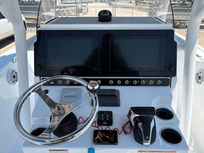 Slide: The Image of 2021 Sportsman Heritage 241 Center Console dashboard with Garmin displays and steering wheel. - 17