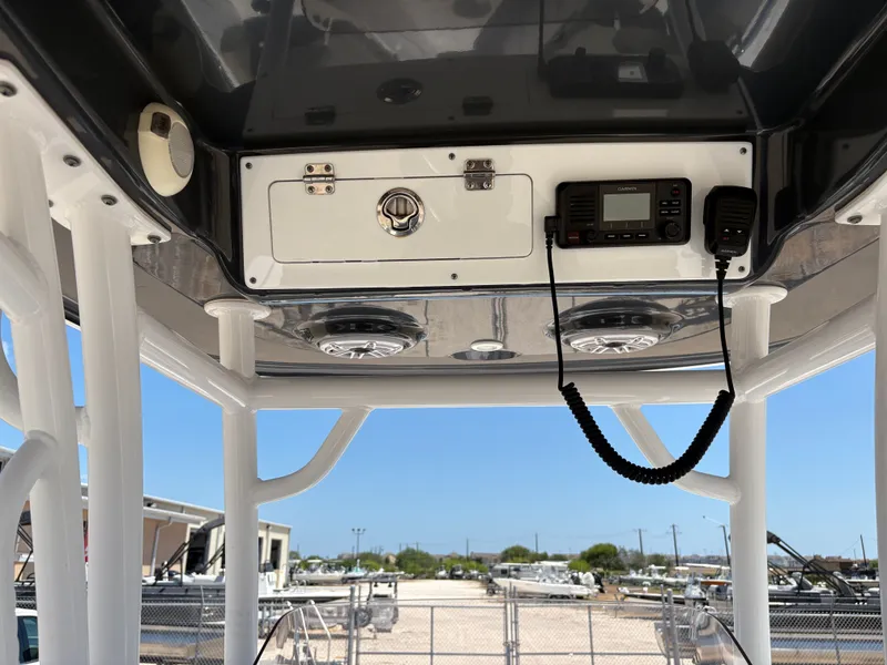 Slide: The Image of 2021 Sportsman Heritage 241 Center Console boat dashboard with radio and speakers. - 19