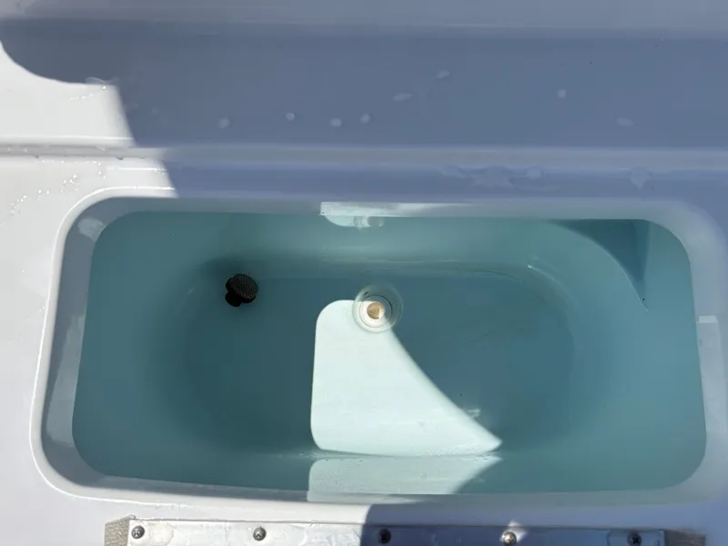 Slide: The Image of Livewell in 2021 Sportsman Heritage 241 Center Console boat, filled with water. - 24