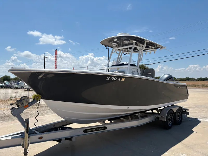Slide: The Image of 2021 Sportsman Heritage 241 Center Console boat on trailer under clear blue sky. - 3