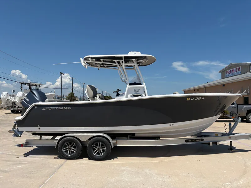 Slide: The Image of 2021 Sportsman Heritage 241 Center Console boat on trailer under clear blue sky. - 7