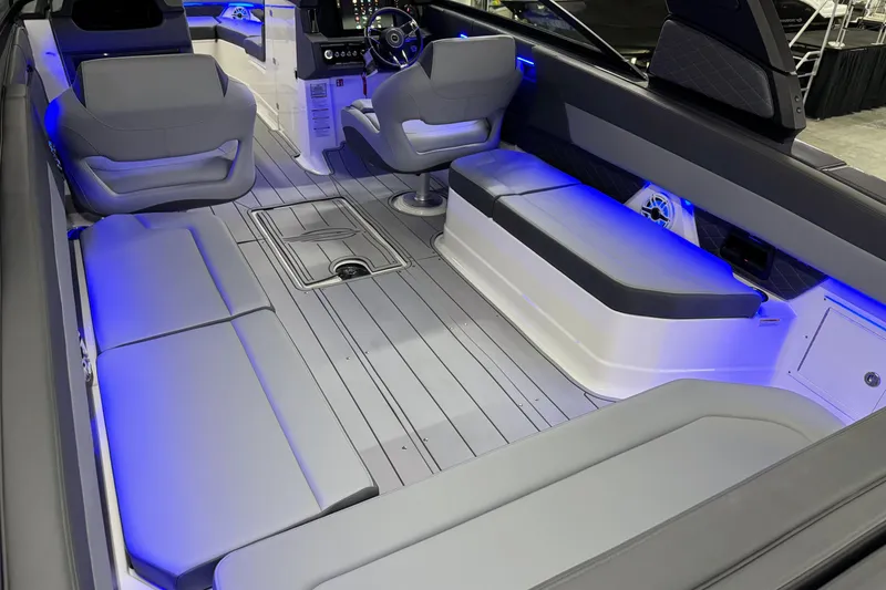 Slide: The Image of 2026 Chaparral 30 SSX boat interior with modern seating and ambient blue lighting. - 10