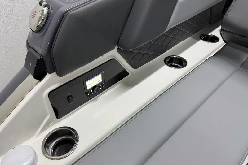 Slide: The Image of 2026 Chaparral 30 SSX boat interior with cup holders and control panel. - 11