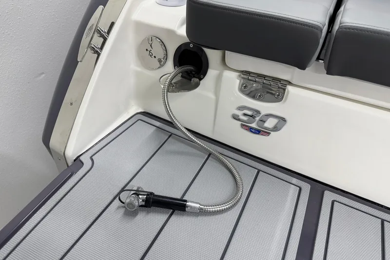 Slide: The Image of 2026 Chaparral 30 SSX boat deck with hose and seating area. - 12