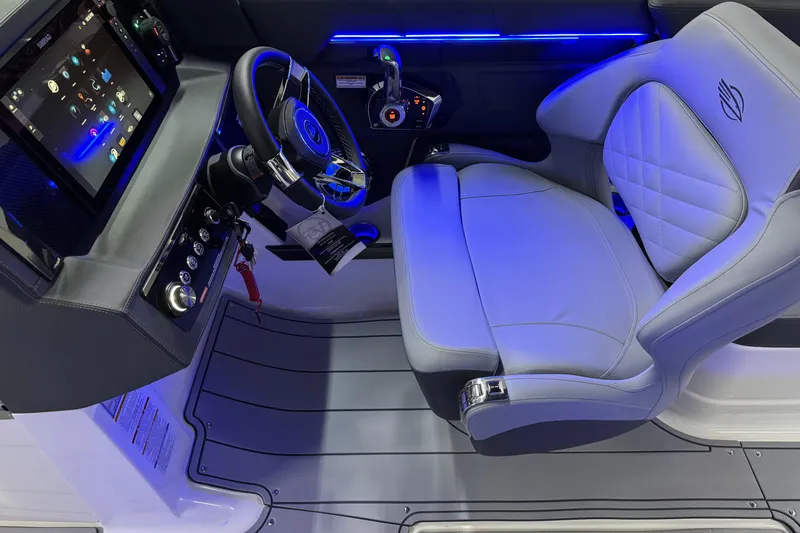Slide: The Image of 2026 Chaparral 30 SSX boat cockpit with modern steering and illuminated controls. - 23