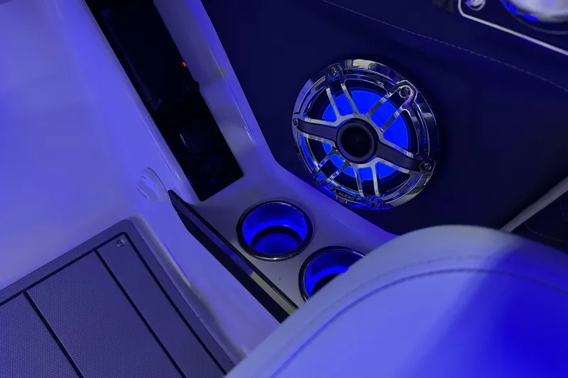 Slide: The Image of 2026 Chaparral 30 SSX boat interior with illuminated speaker and cup holders. - 28