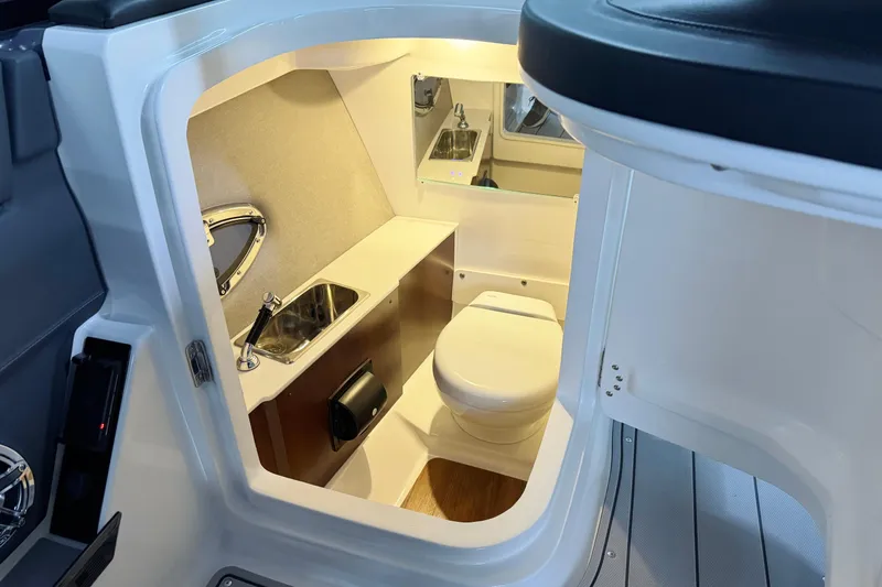 Slide: The Image of 2026 Chaparral 30 SSX boat interior with compact bathroom and sink. - 35