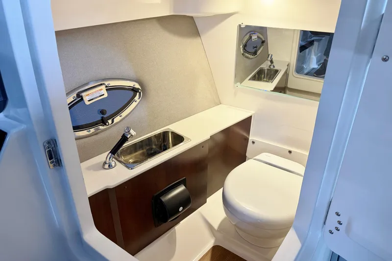 Slide: The Image of 2026 Chaparral 30 SSX boat bathroom with sink, toilet, and mirror. - 36
