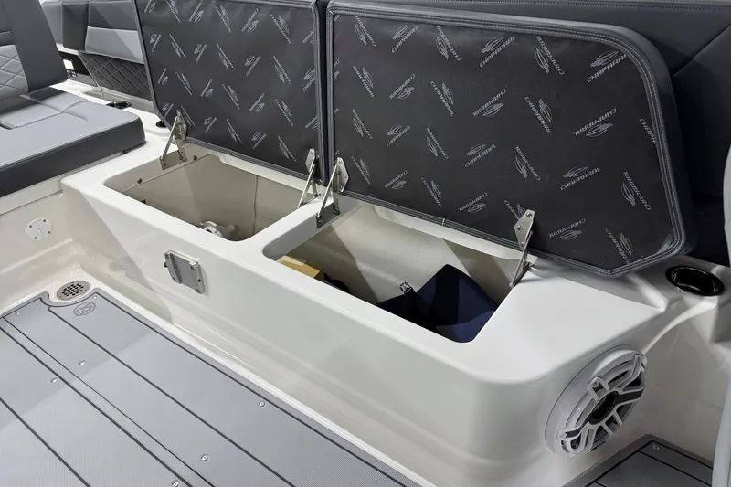Slide: The Image of 2026 Chaparral 30 SSX boat interior storage compartments with open lids and speaker. - 40