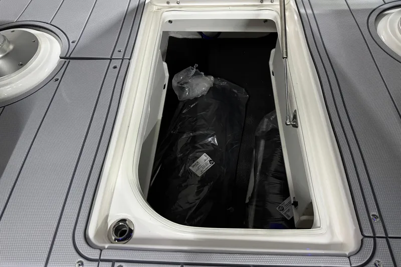 Slide: The Image of Storage compartment on 2026 Chaparral 30 SSX boat with gray deck. - 47