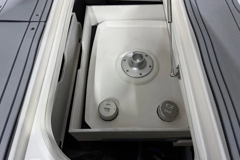 Slide: The Image of 2026 Chaparral 30 SSX boat storage compartment with hydraulic lift and secure fittings. - 49