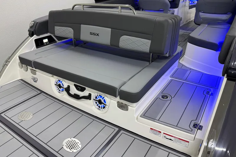 Slide: The Image of 2026 Chaparral 30 SSX boat interior with gray seating and blue LED lighting. - 5