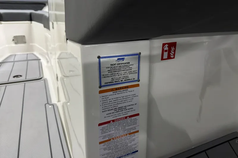 Slide: The Image of 2026 Chaparral 30 SSX boat interior with safety certification and warning labels. - 50