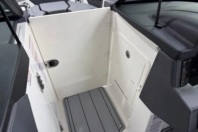 Slide: The Image of 2026 Chaparral 30 SSX boat interior with storage compartment and sleek design. - 52