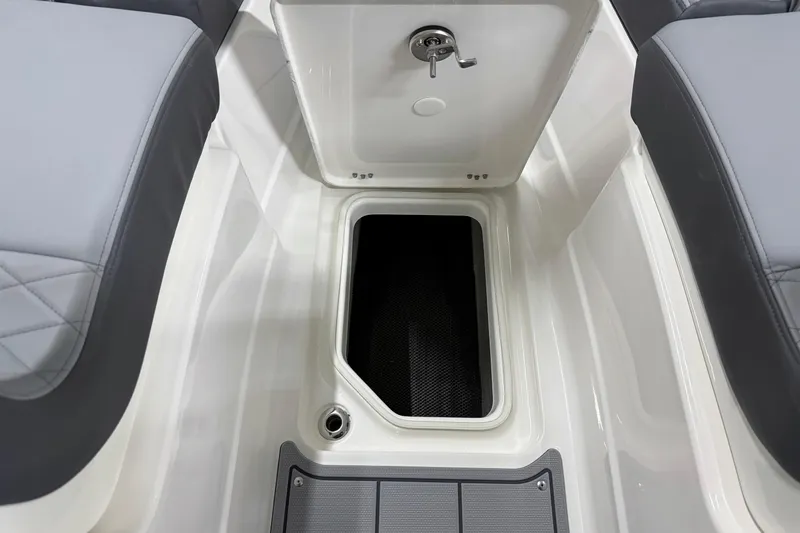 Slide: The Image of 2026 Chaparral 30 SSX boat storage compartment with gray seating. - 57