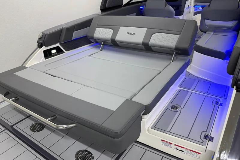 Slide: The Image of 2026 Chaparral 30 SSX boat interior with gray seating and blue LED lighting. - 6