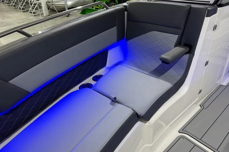 Slide: The Image of 2026 Chaparral 30 SSX boat interior with blue LED lighting and cushioned seating. - 61