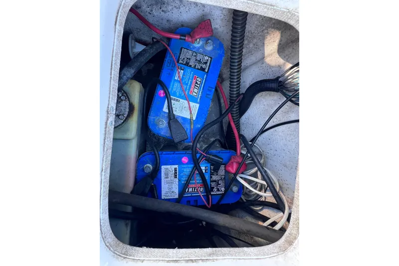 Slide: The Image of 2013 Carolina Skiff 218 DLV boat battery compartment with wiring. - 18