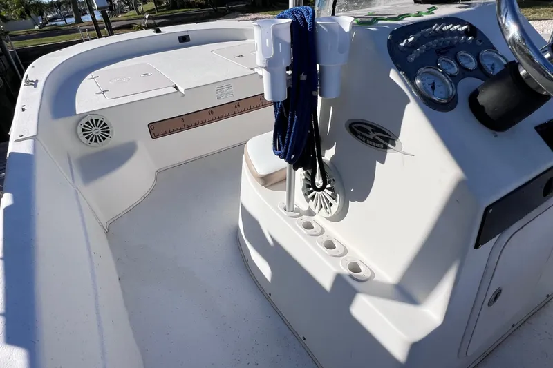 Slide: The Image of 2013 Carolina Skiff 218 DLV boat interior with console and storage compartments. - 20