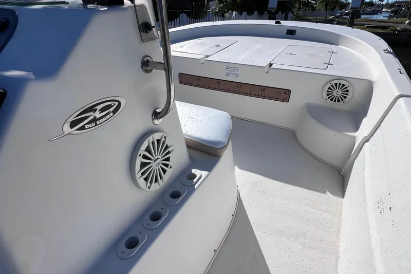 Slide: The Image of 2013 Carolina Skiff 218 DLV boat interior with seating and speakers. - 21