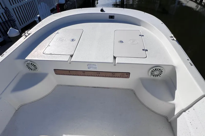Slide: The Image of 2013 Carolina Skiff 218 DLV boat deck with storage compartments and speakers. - 22