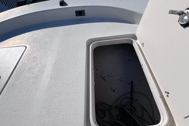 Slide: The Image of Open storage compartment on 2013 Carolina Skiff 218 DLV boat deck. - 25