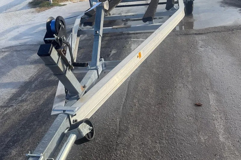 Slide: The Image of Boat trailer for 2013 Carolina Skiff 218 DLV on wet pavement. - 3