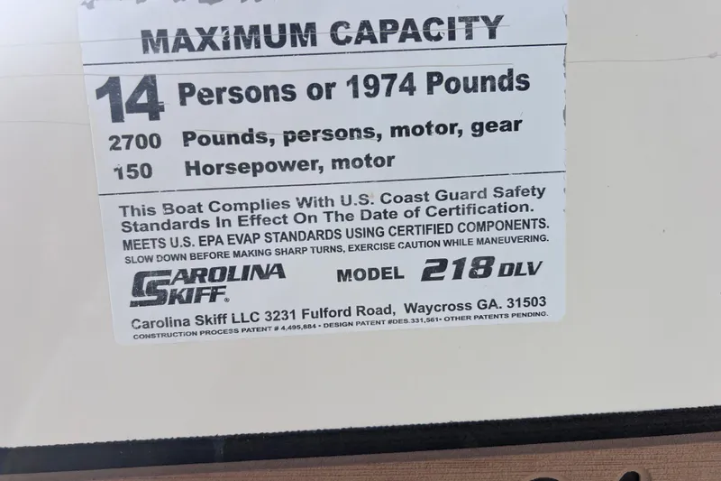 Slide: The Image of 2013 Carolina Skiff 218 DLV capacity label, 14 persons or 1974 pounds, 150 horsepower. - 35
