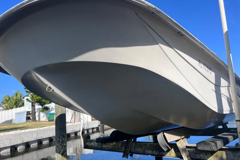 Slide: The Image of 2013 Carolina Skiff 218 DLV boat on a lift, viewed from below. - 6