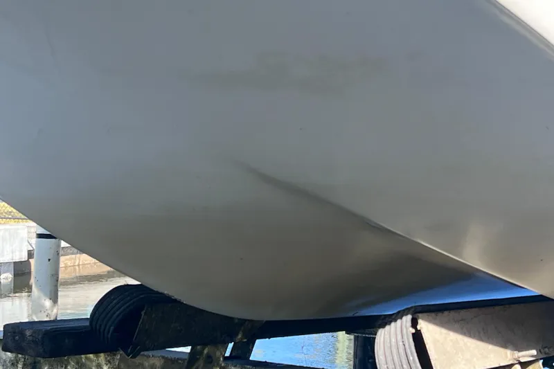 Slide: The Image of 2013 Carolina Skiff 218 DLV boat hull on trailer, close-up view. - 7