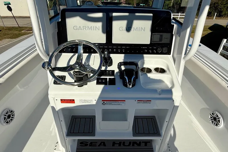 Slide: The Image of 2026 Sea Hunt Ultra 275 Coffin Box boat dashboard with Garmin displays and steering wheel. - 10