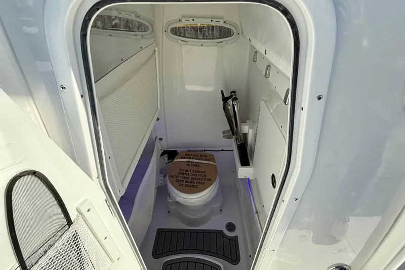 Slide: The Image of Interior of 2026 Sea Hunt Ultra 275 Coffin Box boat's compact bathroom. - 13