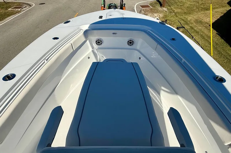 Slide: The Image of 2026 Sea Hunt Ultra 275 Coffin Box boat interior with seating and speakers. - 14