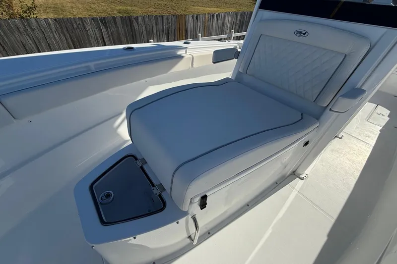 Slide: The Image of 2026 Sea Hunt Ultra 275 Coffin Box boat interior with cushioned seating. - 22