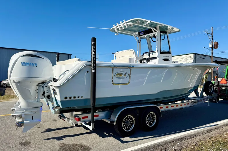 Slide: The Image of 2026 Sea Hunt Ultra 275 Coffin Box boat on trailer, featuring Yamaha engine. - 4