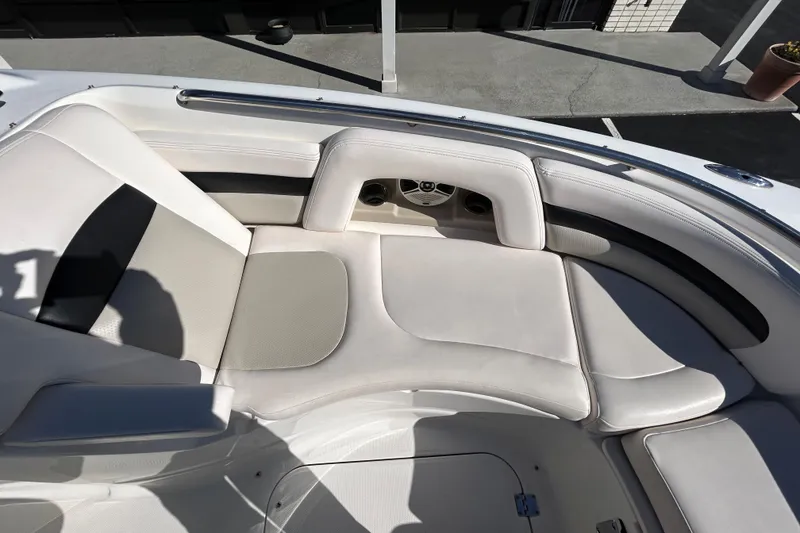Slide: The Image of 2009 Chaparral Sunesta 264 boat interior with white cushioned seating. - 10