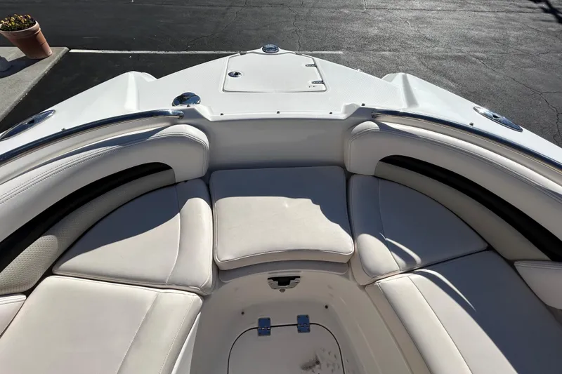 Slide: The Image of 2009 Chaparral Sunesta 264 boat interior with white cushioned seating. - 11