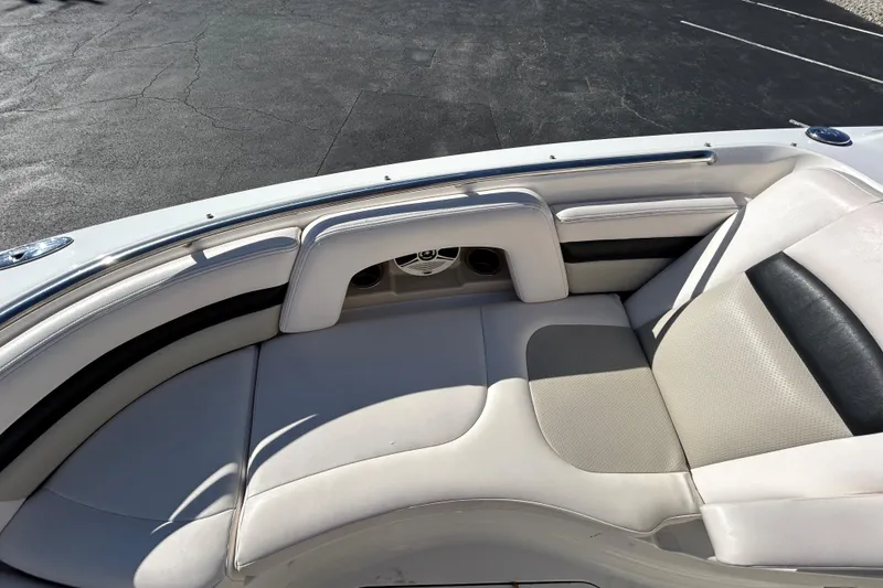 Slide: The Image of 2009 Chaparral Sunesta 264 boat interior with white cushioned seating. - 12