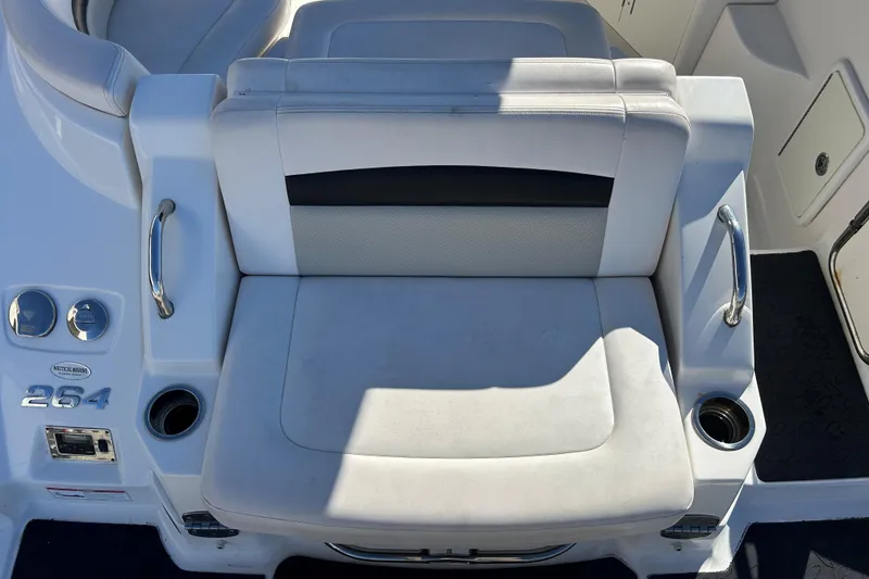 Slide: The Image of 2009 Chaparral Sunesta 264 boat seating area with cup holders and handles. - 17