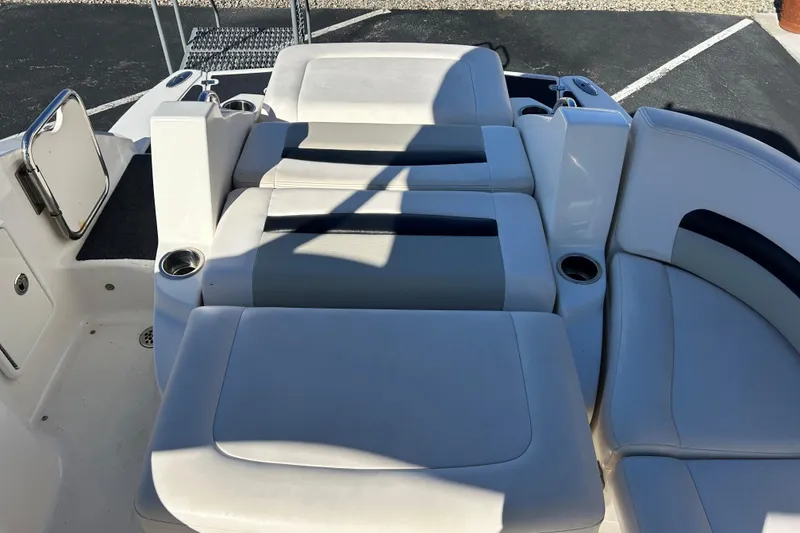 Slide: The Image of 2009 Chaparral Sunesta 264 boat interior with white seating and cup holders. - 18
