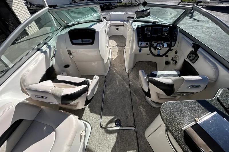 Slide: The Image of Interior of a 2009 Chaparral Sunesta 264 boat with modern seating and controls. - 21
