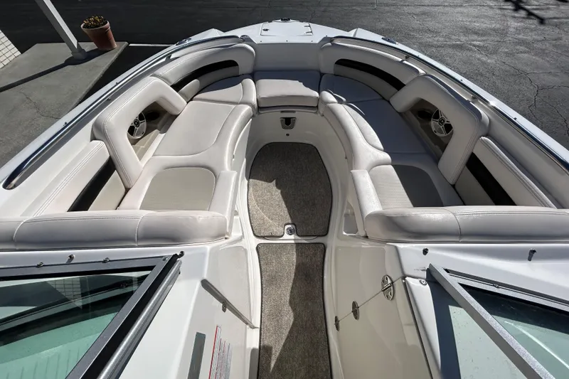Slide: The Image of 2009 Chaparral Sunesta 264 boat interior with spacious seating and carpeted floor. - 22